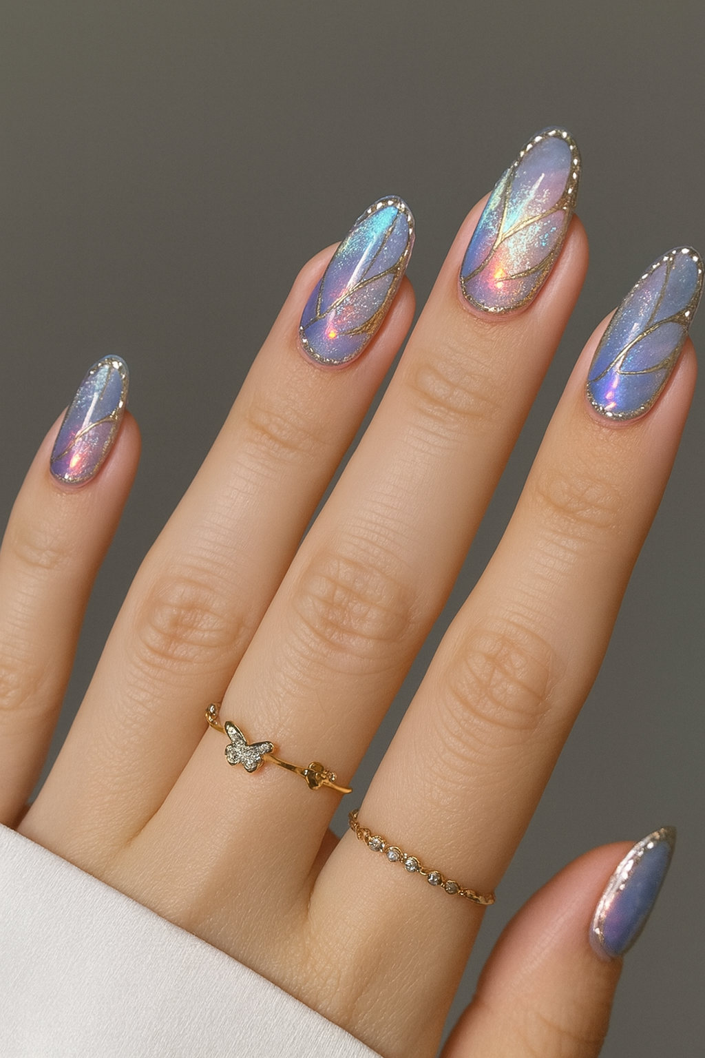 Almond nails with holographic shimmer and gold line details