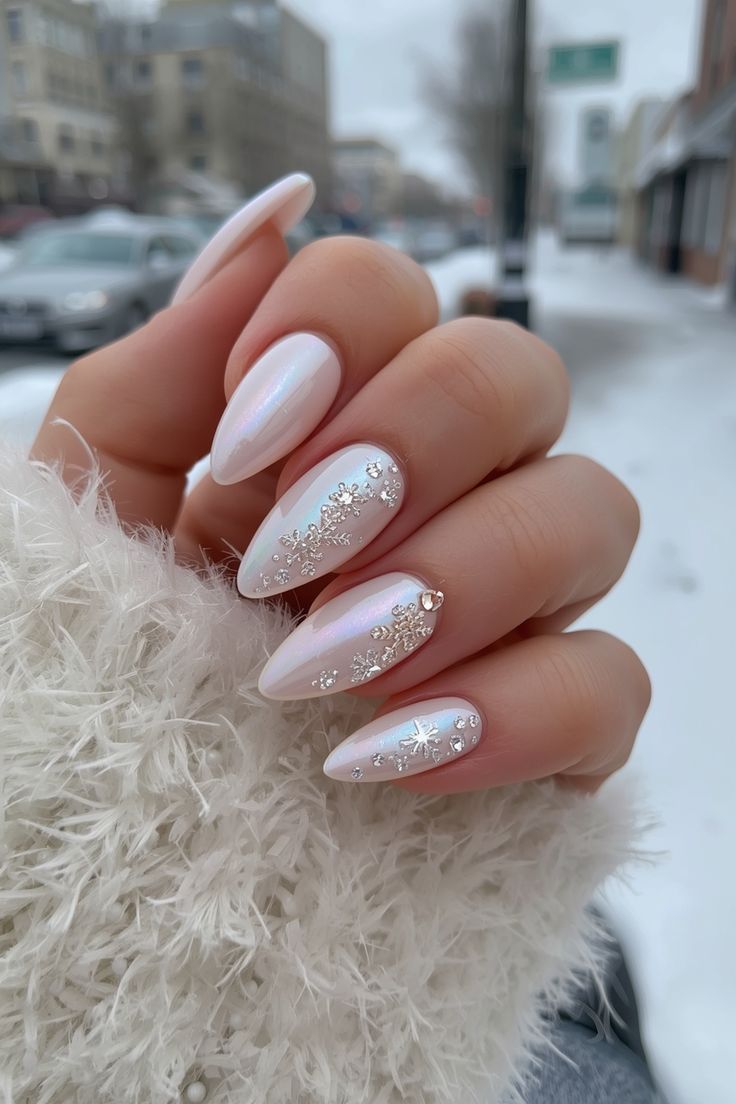 White pearl nails decorated with crystal snowflakes