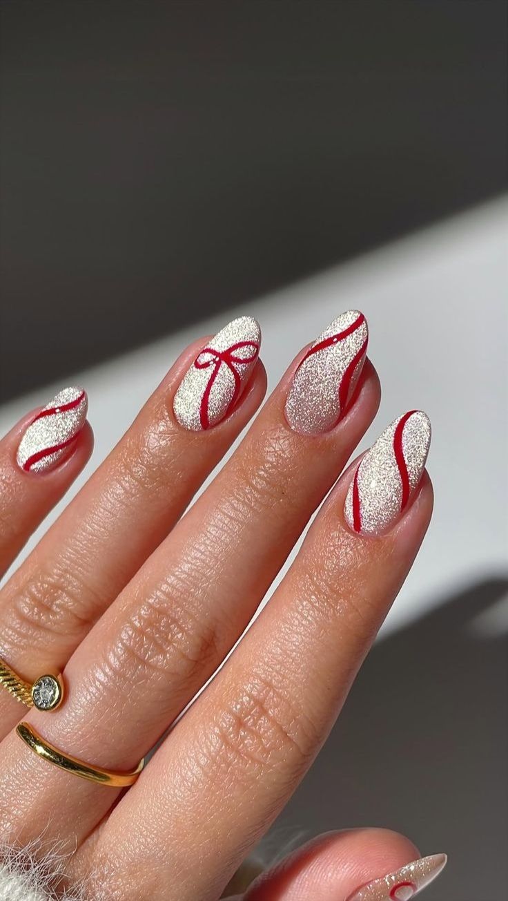 White glitter nails with red ribbon-style lines